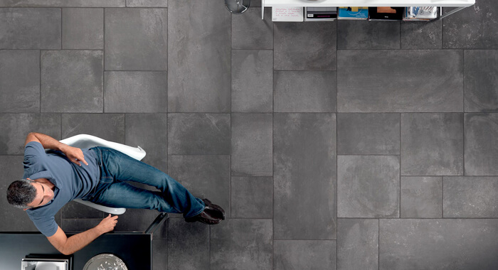 Man sitting on grey stone tiles